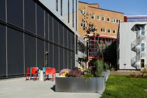 a patio with chairs and tables in front of a building at Pingvinhotellet UNN Tromsø in Tromsø