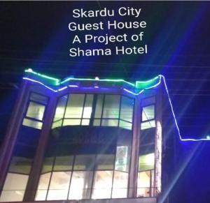 a building with blue and green lights on it at Skardu city Guest house in Skardu
