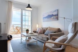 a living room with a couch and a table at AT Tino Casal in Almería