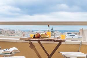 a tray of fruit on a table on a balcony at AT Tino Casal in Almería