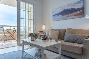 a living room with a couch and a table at AT Tino Casal in Almería
