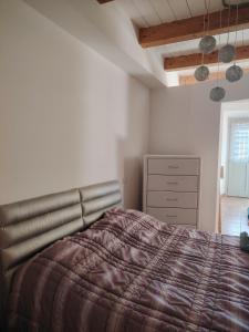 a bedroom with a bed and a dresser at Babahouse in Camerano