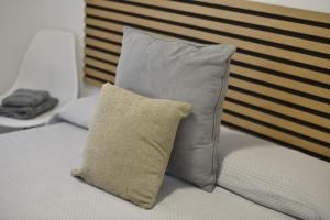 two pillows sitting on top of a bed at La coqueta in Murcia