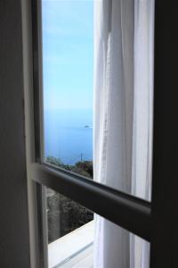 a view of the ocean from a window at My Place Your Place in Corniglia
