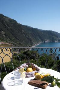 a basket of fruit on a table with a view of the ocean at My Place Your Place in Corniglia