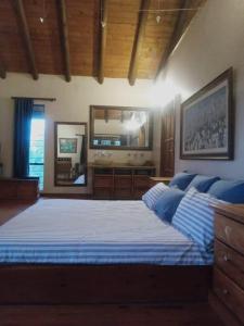 a large bedroom with a large bed with blue pillows at Coming Home in Centurion