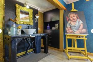 a bathroom with a painting of a baby on the wall at Casa Miramiranda in Teià