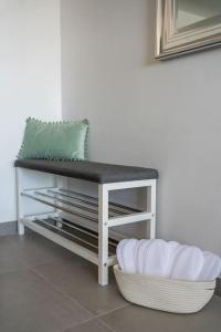 a white table with a green pillow on top of it at LA88 Cityway Apartment 5 in Il-Gżira
