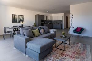 a living room with a couch and a table at LA88 Cityway Apartment 5 in Il-Gżira