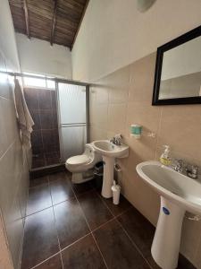 a bathroom with a toilet and a sink at Hermosa Cabaña Campestre en Chinacota in Chinácota