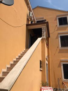 an entrance to a building with stairs on the side at Apartments Cunski in Čunski