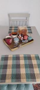 a tray with bowls and cups on a table at Orizodas in Lipsoi