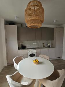 a white table with chairs and a bowl of fruit on it at Il Vento in Split +26 photos