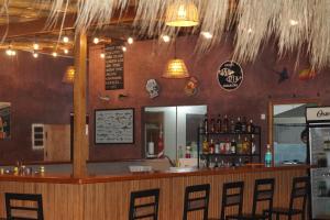 un bar en un restaurante con barra y sillas en Hotel Gran Azul Bungalows, en Canoas de Punta Sal