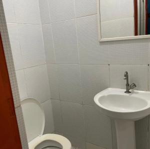 a bathroom with a toilet and a sink at Pousada pirata in Recife