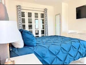 a blue bed in a room with a window at Elegant Condo in an Upscale Building in Cabo San Lucas +32 photos