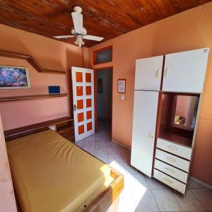 a bedroom with a bed and a refrigerator at Pousada pirata in Recife