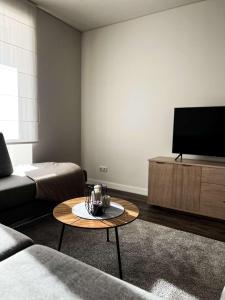 a living room with a couch and a coffee table at Milastos apartamentai in Birštonas