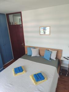 a bedroom with two beds with blue pillows on them at HushHush Apartman in Belgrade