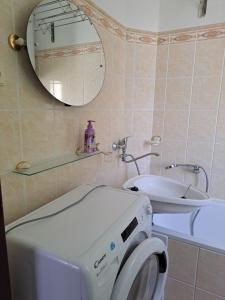 a bathroom with a washing machine and a sink at Apartmán U Rogala in Děčín
