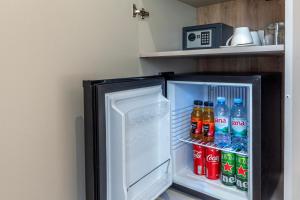an open refrigerator filled with soda and sodas at Teuta Garden Luxury Room in Split
