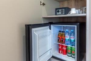 een open koelkast gevuld met frisdrank en frisdrank bij Teuta Garden Luxury Room in Split