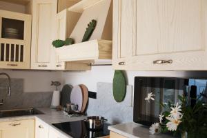 a kitchen with wooden cabinets and a microwave at My Place Your Place in Corniglia +38 photos