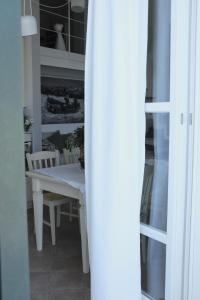 a dining room with a white table and chairs at My Place Your Place in Corniglia