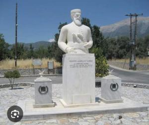 a statue of a man standing in the middle of a road at house FYNTIKAKH - SKALA in Anopoli Sfakion