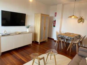 a living room with a couch and a table at V&B VACACIONAL in Suances