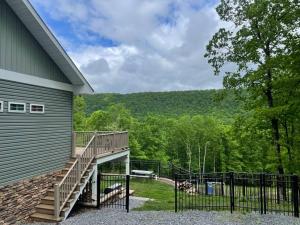 a house with a wooden staircase next to a building at Luxury Mountain Home in Huntingdon