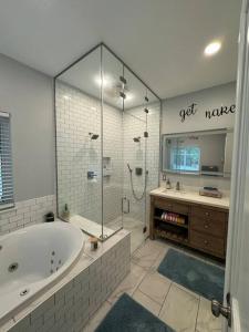 a large bathroom with a tub and a shower at Luxury Mountain Home in Huntingdon