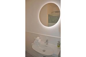 a bathroom with a sink and a mirror at Apartment Austria 206 am Traunsee, Gmunden in Gmunden +11 photos