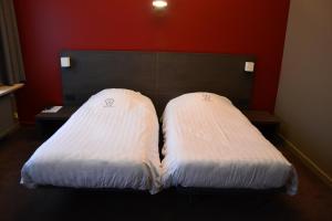Postel nebo postele na pokoji v ubytování Hotel De Franse Kroon