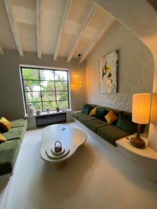 a living room with a couch and a coffee table at Heretat de Sant joan in Ferreries +58 photos