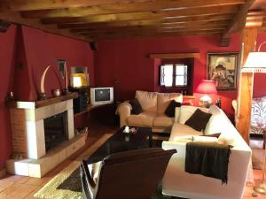 a living room with a couch and a fireplace at Casa El Puente, casa típica totalmente restaurada in Potes