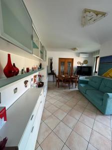 a living room with a couch and a table at Appartamento Silvia in Santa Veneranda +6 photos