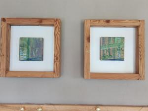 two wooden frames on a wall with paintings at Guikuri Octogono casa rural 1, 2 y 3pax in Múrua