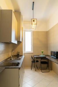 a kitchen with a sink and a table at B&B Cateum in Andria