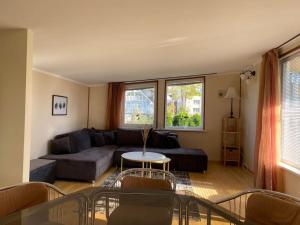 a living room with a couch and a table at Perfectly located summerhouse in Druskininkai