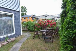a patio with a table and chairs and an umbrella at Perfectly located summerhouse in Druskininkai