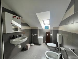 a bathroom with a sink and a toilet and a mirror at Appartamenti Papavero e Iris in Albaretto Della Torre  +34 photos