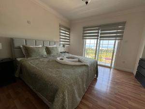 a bedroom with a large bed with a large window at Hillside Villa with Sea Views in Kyrenia +73 photos