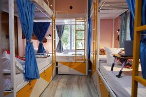 a dorm room with beds and a window at The Nerd Nest Kolkata in Kolkata