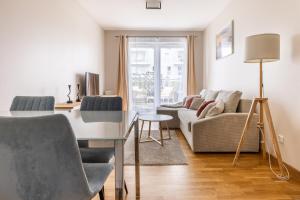 a living room with a desk and a couch at Baltic Apartments Seaside Towers in Gdańsk