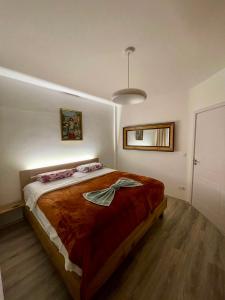 a bedroom with a large bed in a room at Empress N Apartment in Kosovo Polje