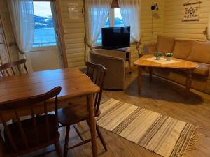 a living room with a table and a couch at Yttervik in Skamdal