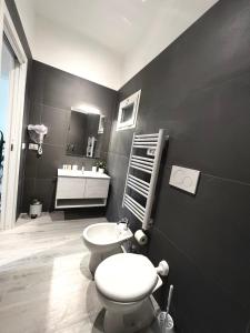 a black bathroom with a toilet and a sink at Villa Rita in Corato