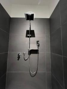 a shower in a bathroom with a shower head at Villa Rita in Corato