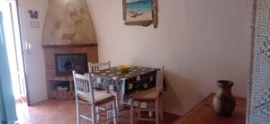 a dining room with a table and chairs and a fireplace at Estudio Cala Saona in Cala Saona